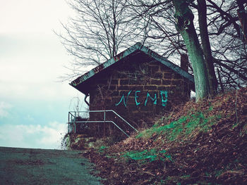 Low angle view of text on building against sky