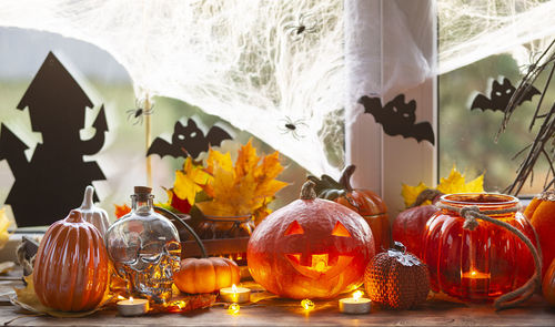 Close-up of various pumpkins in glass container