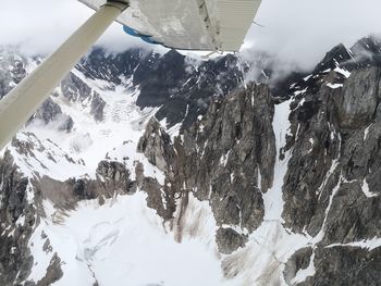 Scenic view of snow covered mountains against sky