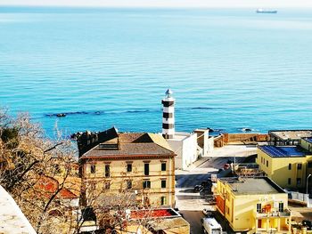 High angle view of buildings by sea against sky