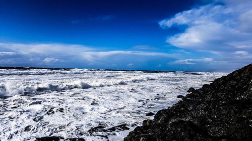 Scenic view of landscape against blue sky