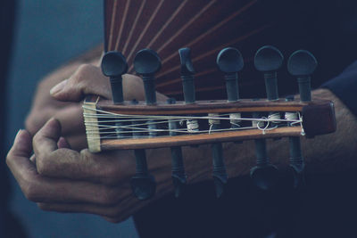 Cropped hands of person playing musical instrument