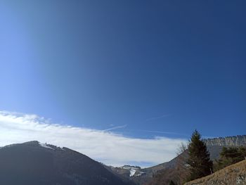 Low angle view of mountain against blue sky