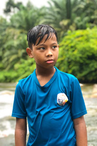 Portrait of boy standing outdoors