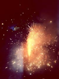 Low angle view of firework display at night