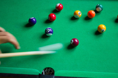 Cropped hand of person playing snooker