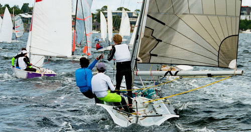 Rear view of people on boat in sea