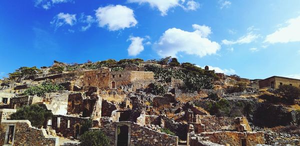 Old ruin buildings on mountain against sky