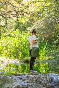 Rear view of woman walking in forest