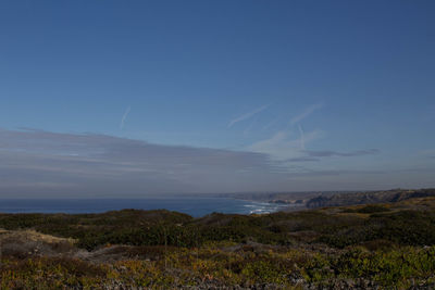 Scenic view of sea and landscape against sky