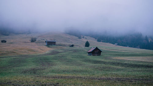 Scenic view of landscape against sky during foggy weather