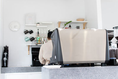 Close-up of laptop on table against wall