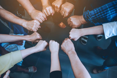 Midsection of couple holding hands