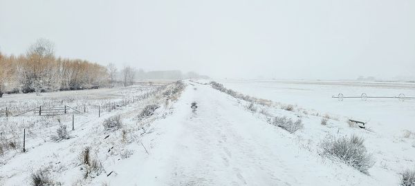 Snow covered road against sky