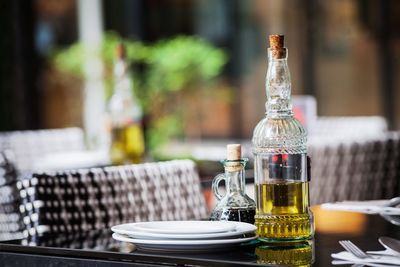 Close-up of wine bottles on table at cafe