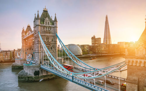 Tower bridge over river with buildings in background