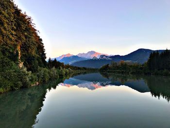 Scenic view of lake and mountains against clear sky