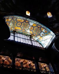 Low angle view of illuminated ceiling in old building