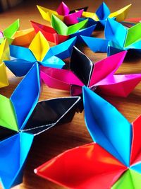 Colorful paper flowers on table at home