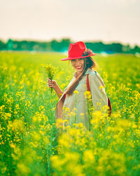 Rear view of woman walking on field