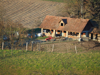 House on field against houses
