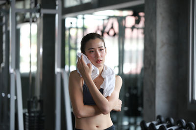 Woman wiping sweat with towel at gym