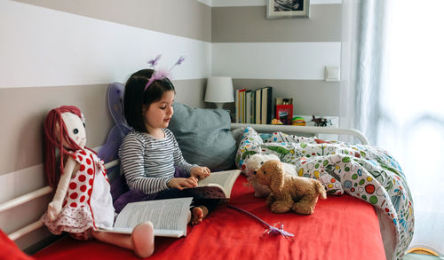 Young woman sitting in bedroom