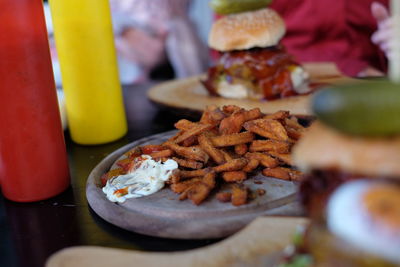 French fries on serving tray at table