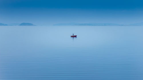 Scenic view of sea against blue sky