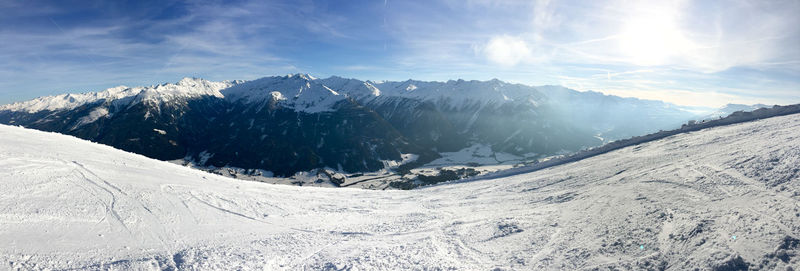 Scenic view of snow covered mountains against sky