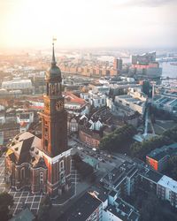 Aerial view of cityscape against sky during sunset