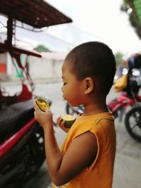 Side view of boy looking at bus