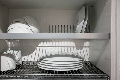 Crockery arranging in rack at home
