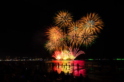 Low angle view of firework display at night