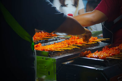 Man preparing food on barbecue grill