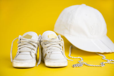 Close-up of shoes against yellow background