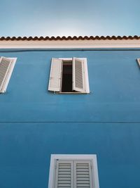 Low angle view of building against blue sky