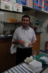 Portrait of smiling man standing at restaurant