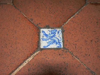 High angle view of painting on tiled floor