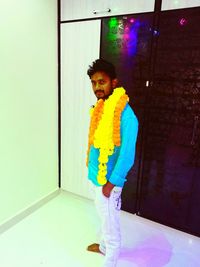 Portrait of young man standing on floor at home