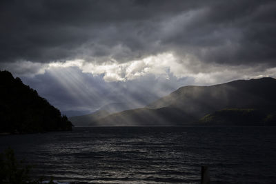 Scenic view of sea against storm clouds