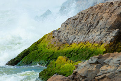 Scenic view of rocky mountain by sea