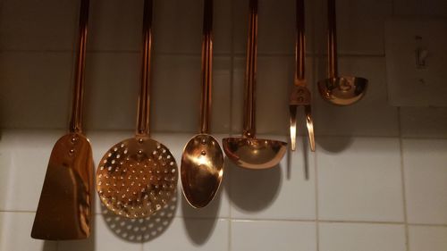 Close-up of electric lamp hanging on wall at home