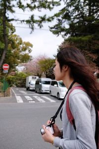 Young woman on road in city