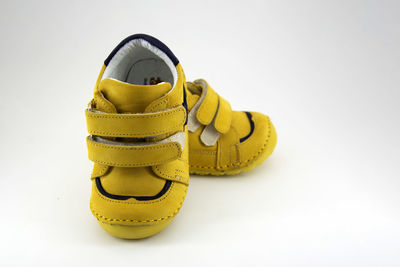 Close-up of shoes on floor against white background