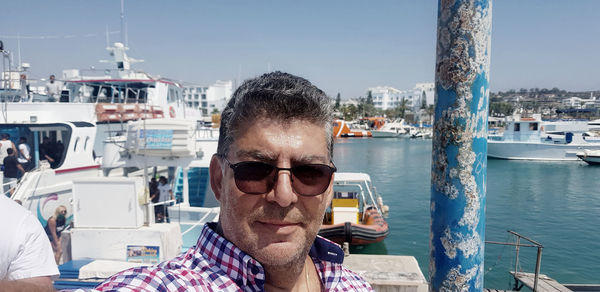 Portrait of man with sunglasses at harbor
