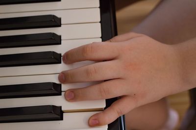 Close-up of baby playing piano