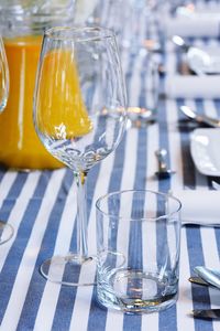 Close-up of empty wineglass and drinking glass on table