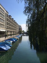 Boats moored in water against clear sky