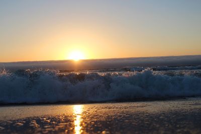 Scenic view of sea against clear sky during sunset